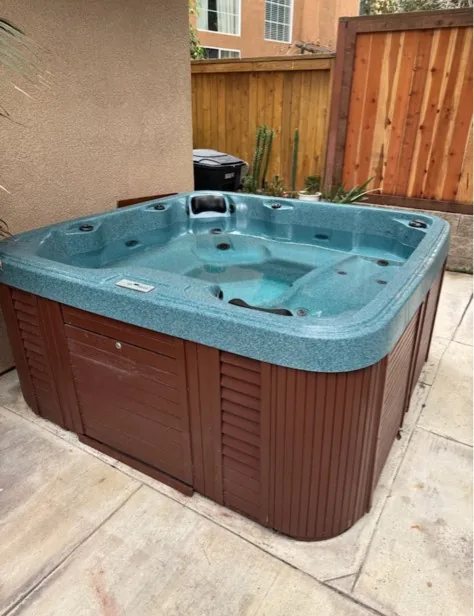 Old backyard hot tub removed by EA Junk Removal in Orange County, CA
